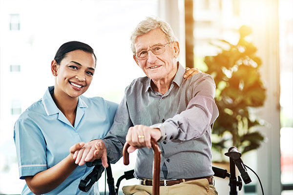 Shot of a young nurse caring for a senior man